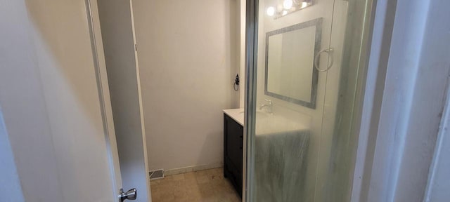 bathroom with vanity, wood finished floors, visible vents, and baseboards