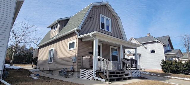 dutch colonial featuring a porch and a gambrel roof