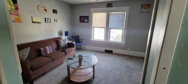 living room with visible vents, baseboards, and carpet