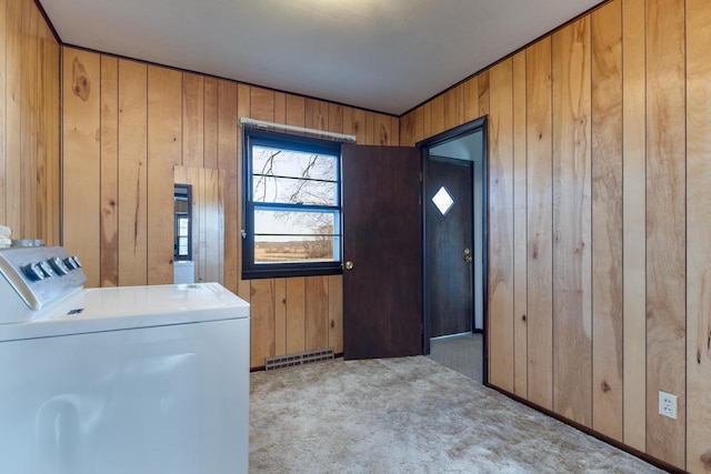 laundry room with visible vents, wooden walls, carpet flooring, and laundry area