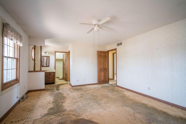 unfurnished bedroom featuring visible vents, wallpapered walls, and baseboards