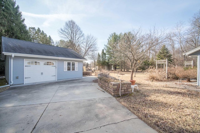 garage featuring concrete driveway