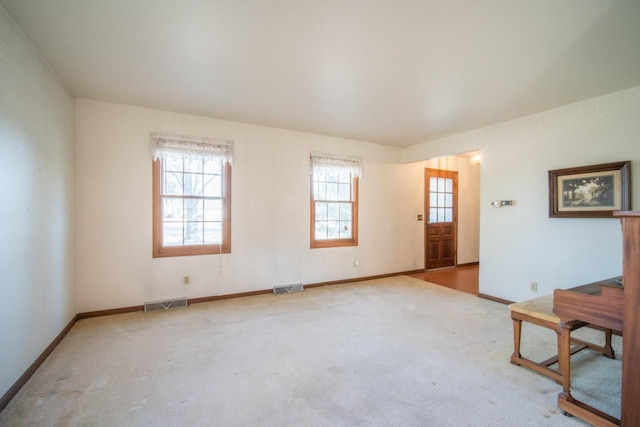 interior space featuring carpet, visible vents, and baseboards