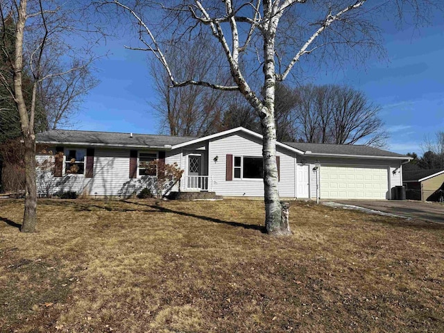 ranch-style house featuring a garage, driveway, and a front yard