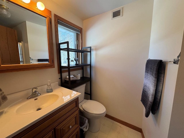 bathroom featuring visible vents, baseboards, toilet, tile patterned floors, and vanity