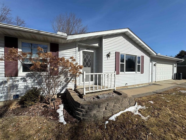 exterior space with concrete driveway and a garage