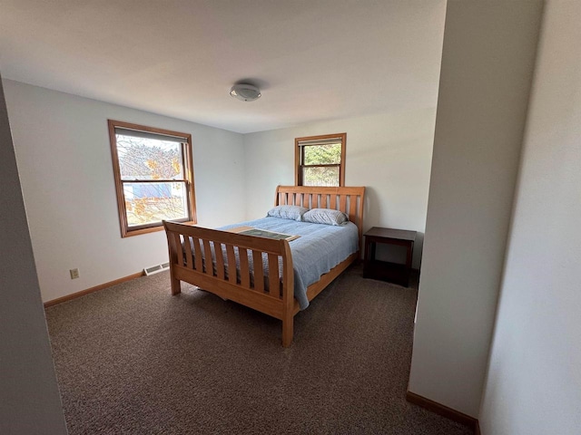 bedroom with carpet, visible vents, and baseboards