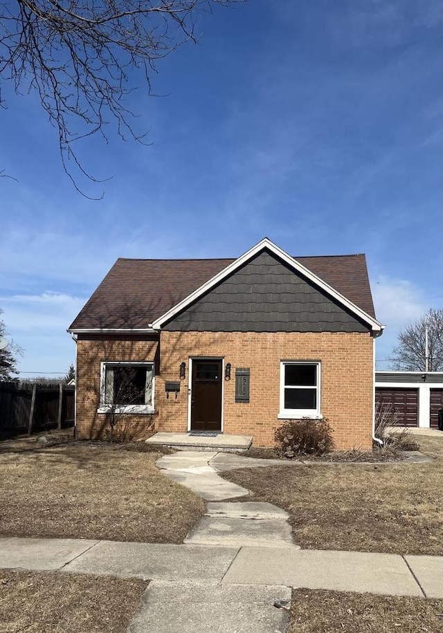 view of front of house featuring a garage and brick siding