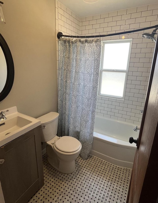 bathroom featuring tile patterned flooring, shower / bath combination with curtain, toilet, and vanity