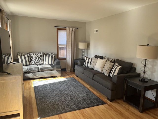 living room featuring visible vents and wood-type flooring