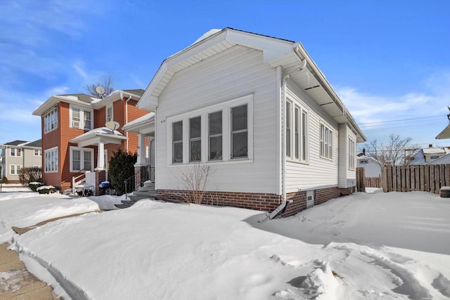 view of front of home featuring fence