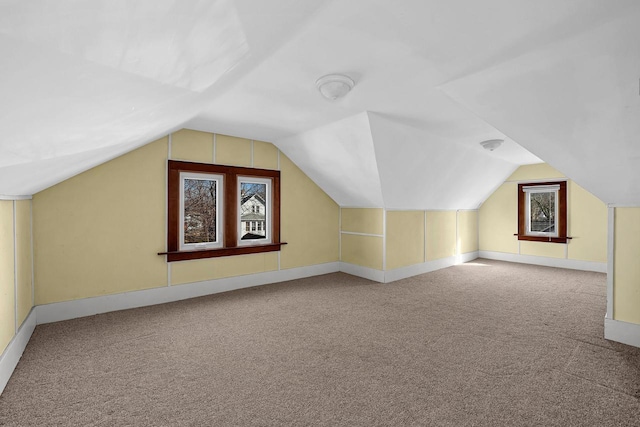 bonus room with lofted ceiling, carpet flooring, and baseboards