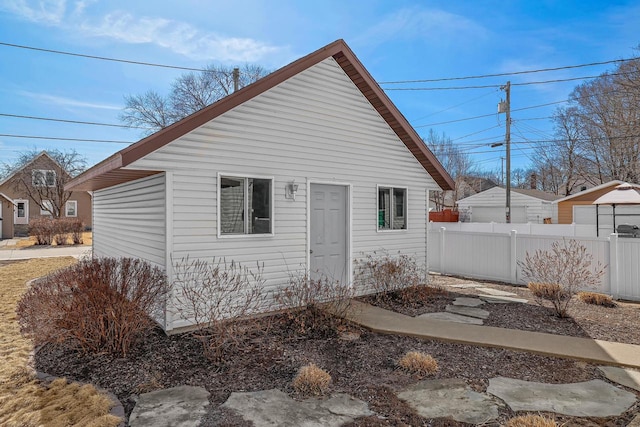 rear view of house featuring fence