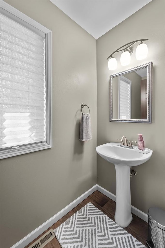 bathroom featuring visible vents, baseboards, and wood finished floors