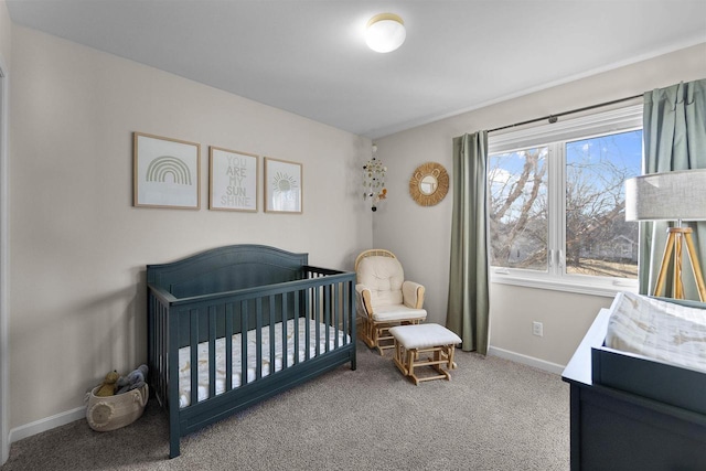 bedroom featuring a crib, carpet, and baseboards