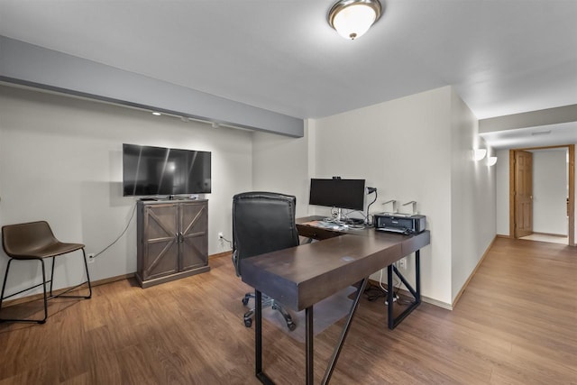 office space featuring wood finished floors and baseboards