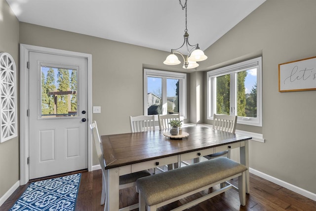 dining area with baseboards, lofted ceiling, dark wood-type flooring, and an inviting chandelier