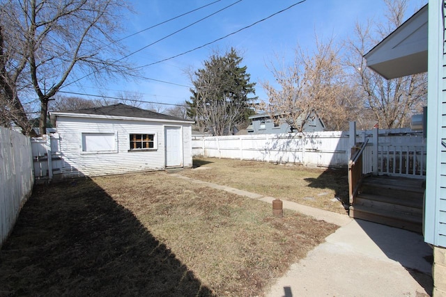 view of yard featuring an outdoor structure and a fenced backyard