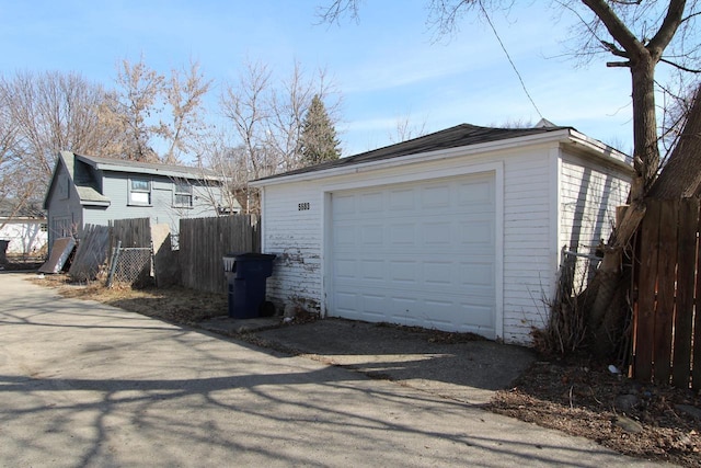 detached garage featuring fence