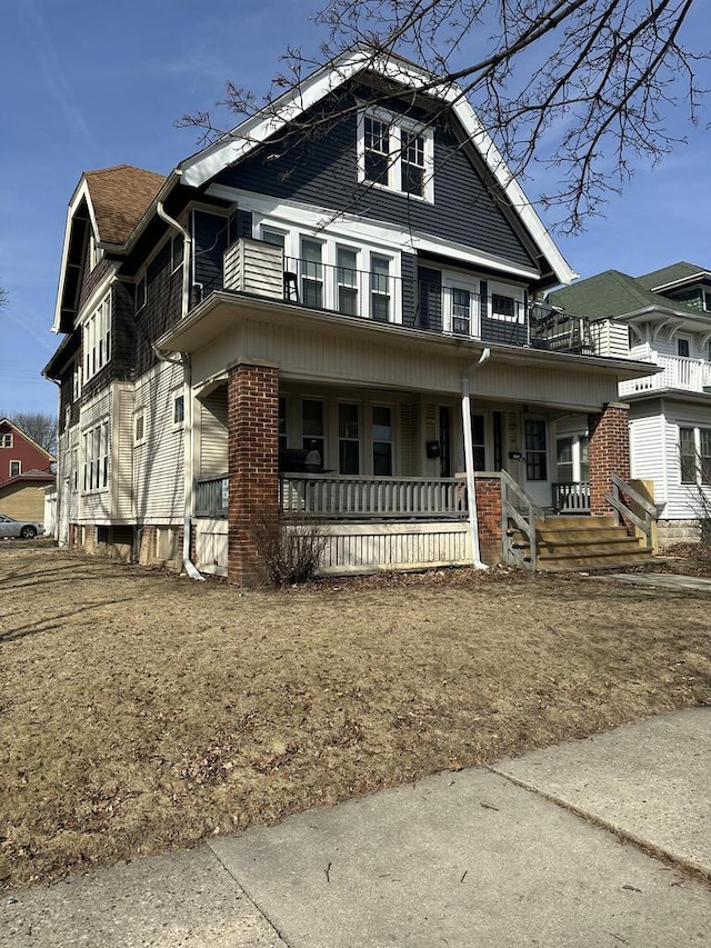 view of front of property with a porch and a balcony