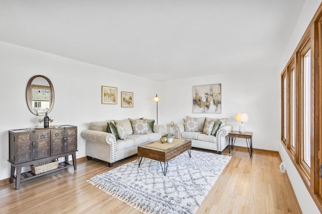 living area with light wood-style floors and baseboards