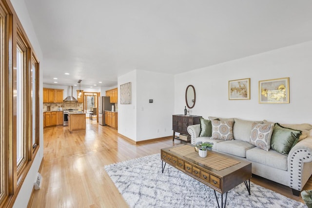 living area featuring recessed lighting, visible vents, baseboards, and light wood finished floors