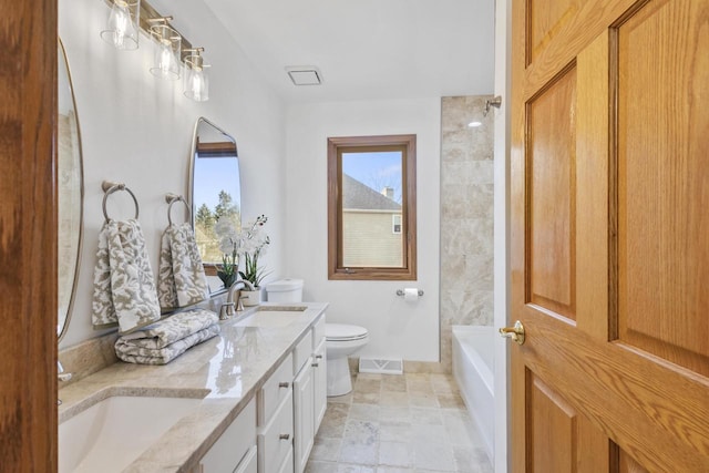 full bathroom with a sink, visible vents, toilet, and double vanity