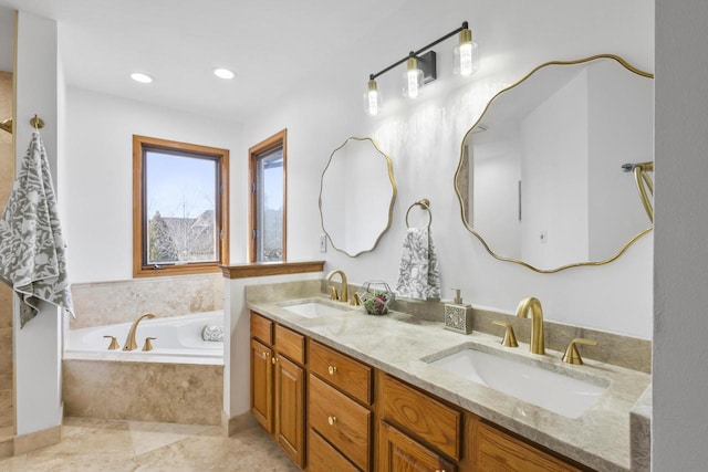 bathroom with a garden tub, recessed lighting, double vanity, and a sink