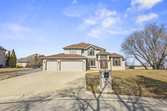 view of front of property featuring a front yard, an attached garage, and driveway