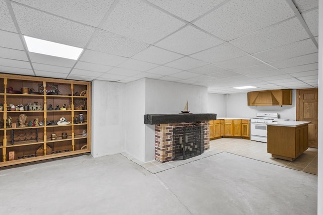 finished basement with a brick fireplace and a drop ceiling