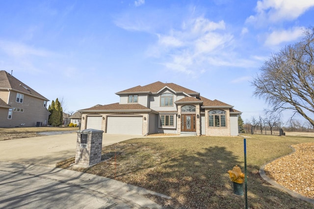 view of front facade with a front lawn, an attached garage, driveway, and roof with shingles