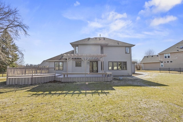 back of property with a wooden deck, a pergola, a yard, and fence