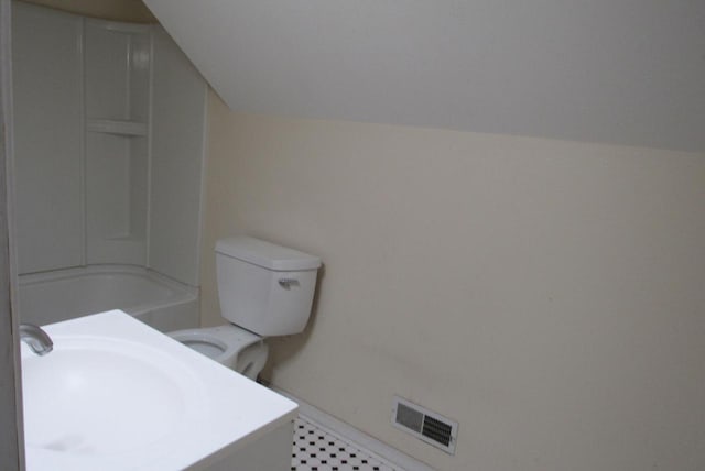 full bath with a sink, visible vents, lofted ceiling, and toilet