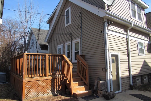 rear view of property featuring central air condition unit and a deck