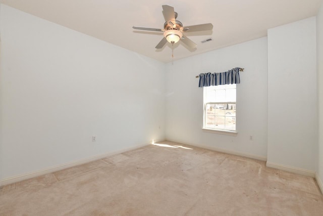 empty room featuring visible vents, baseboards, ceiling fan, and carpet floors