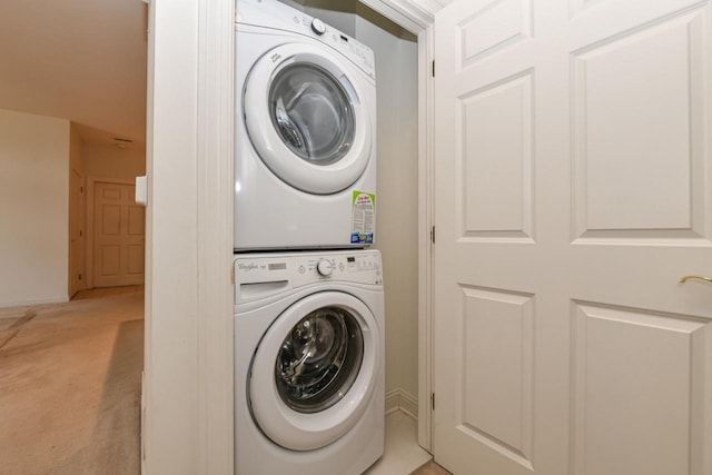 laundry area with laundry area and stacked washer / dryer