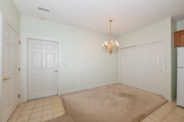 unfurnished dining area with light floors, visible vents, baseboards, light carpet, and a chandelier