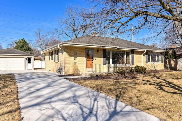 view of front of house featuring an outbuilding, fence, covered porch, a garage, and brick siding