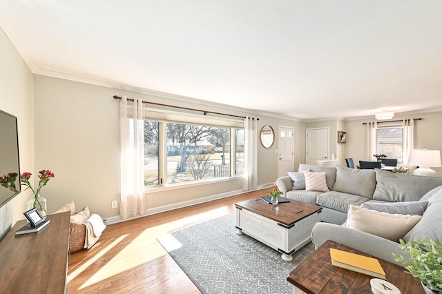 living area with baseboards, wood finished floors, and ornamental molding