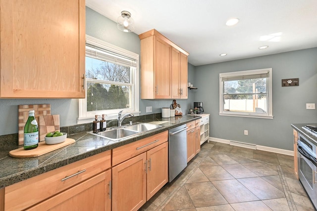 kitchen featuring a sink, dishwasher, light brown cabinetry, and a healthy amount of sunlight