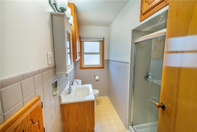 full bath featuring tile patterned floors, vanity, toilet, and a shower stall