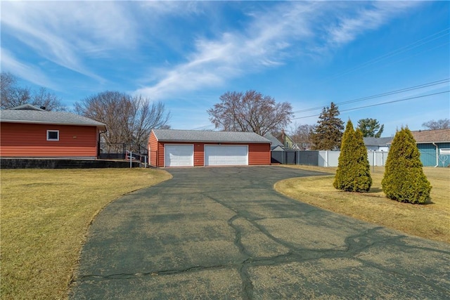 detached garage featuring fence