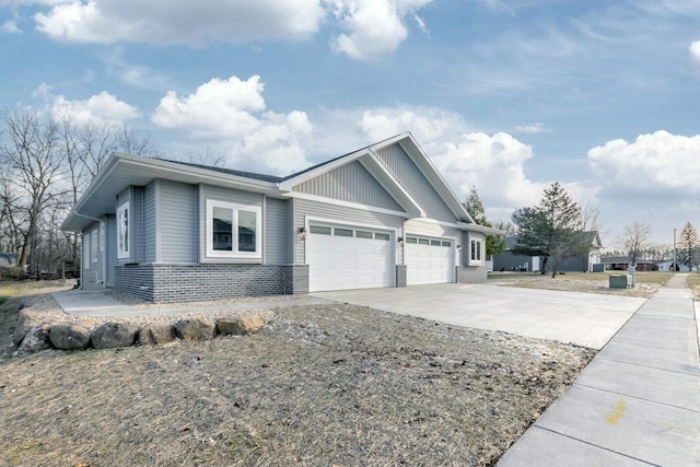 view of property exterior featuring brick siding, an attached garage, and driveway