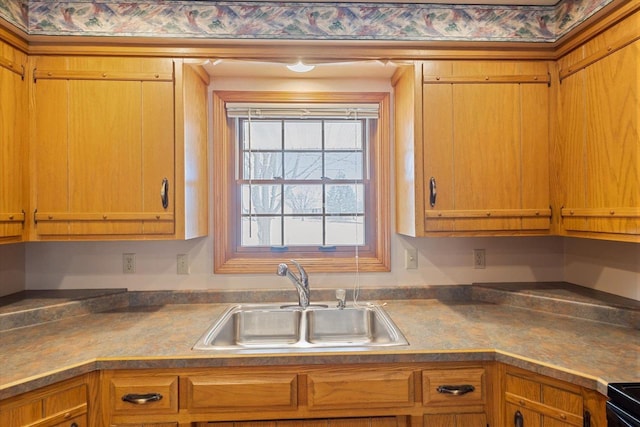 kitchen featuring dark countertops, black / electric stove, and a sink