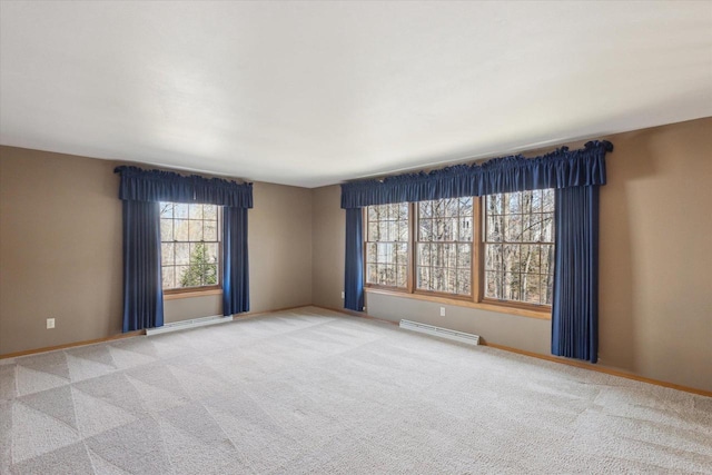 carpeted empty room featuring baseboards and a baseboard radiator