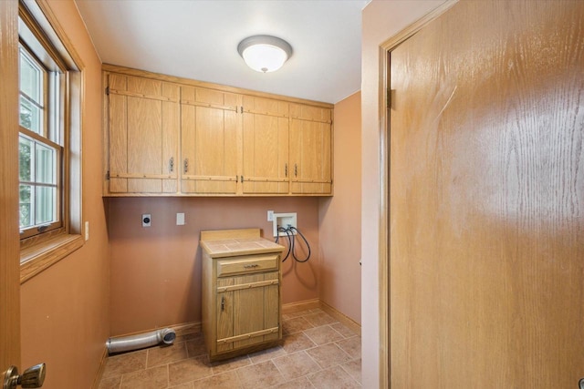 laundry room featuring cabinet space, hookup for an electric dryer, baseboards, and washer hookup