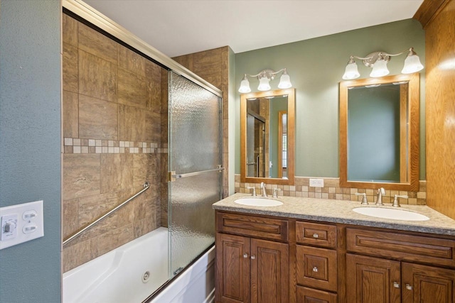 bathroom with enclosed tub / shower combo, backsplash, double vanity, and a sink