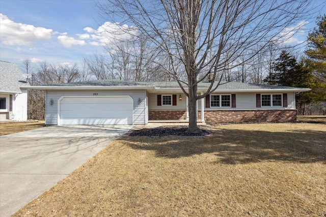 single story home featuring brick siding, an attached garage, driveway, and a front lawn