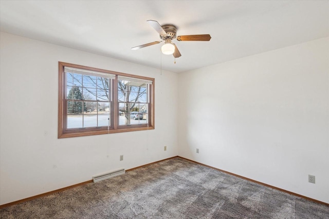 spare room with baseboard heating, baseboards, carpet floors, and ceiling fan