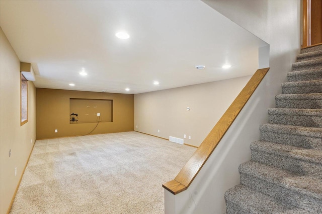 staircase featuring carpet flooring, recessed lighting, visible vents, and baseboards